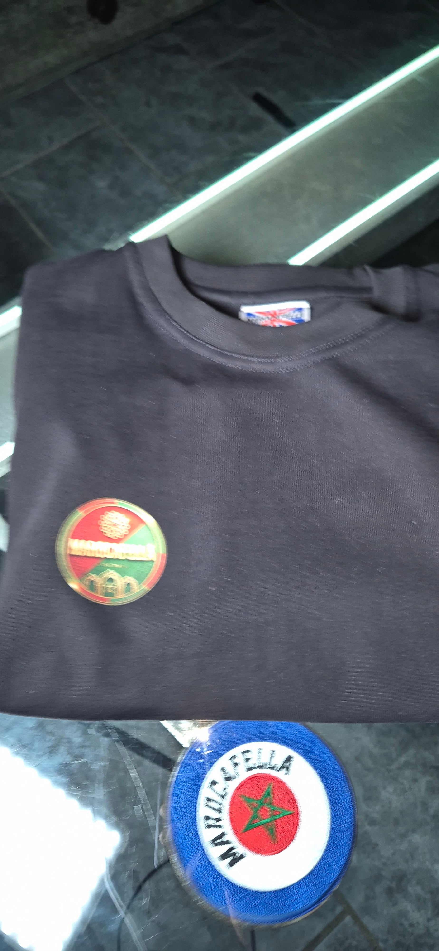 Authentic folded black Marocafella T-shirt with the inside label visible